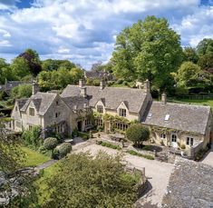 an aerial view of a large house surrounded by trees