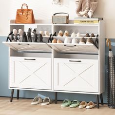 shoes are lined up in front of a white cabinet with doors and drawers on it