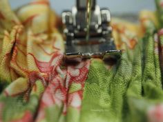 a close up view of a sewing machine with fabric draped around it's sides