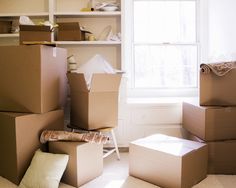 boxes stacked on top of each other in front of a window