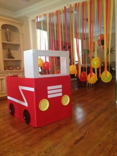 a room filled with lots of balloons and decorations on top of hard wood flooring