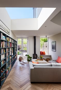 a living room filled with furniture and bookshelves next to a fire place in the corner