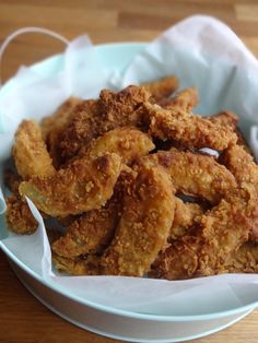 fried chicken sticks in a white bowl on a wooden table