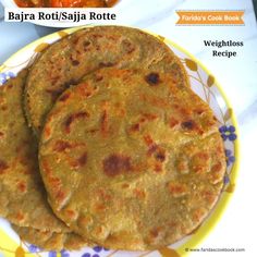 three tortillas on a yellow and white plate next to a bowl of salsa