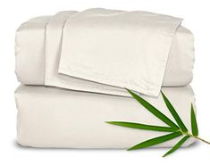 two white sheets and one green leaf on top of each other with the same sheet set