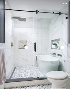 a bathroom with a tub, toilet and shower stall