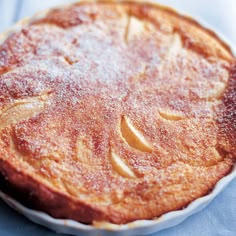 a cake is covered with powdered sugar and sits on a blue napkin, ready to be eaten