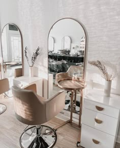 a salon with mirrors, stools and chairs in the middle of it's room