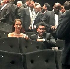 a man and woman sitting in chairs at an event