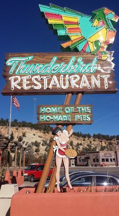 a sign for thunderbird restaurant in front of a car