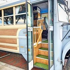 an open door on the side of a bus with grass growing in it's steps