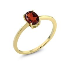 a yellow gold ring with an oval garnet stone