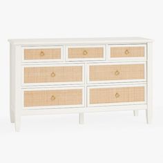 a white and wicker dresser with drawers