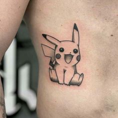 a small tattoo of a pikachu on the side of a man's stomach