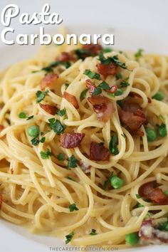 pasta carbonara with bacon, peas and parsley on a white plate text reads pasta carbonara