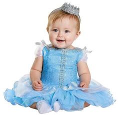 a baby girl wearing a blue dress and a tiara