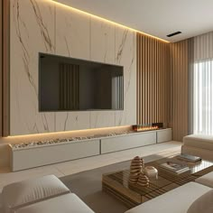 a living room with white couches and a flat screen tv mounted on the wall