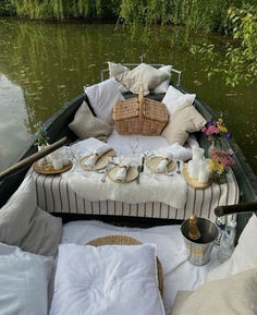 a boat filled with lots of pillows and plates on top of it's side