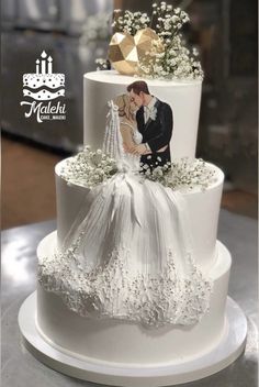 a wedding cake decorated with an image of a bride and groom