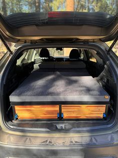 the back end of a car with an open trunk and two sub boxes in it