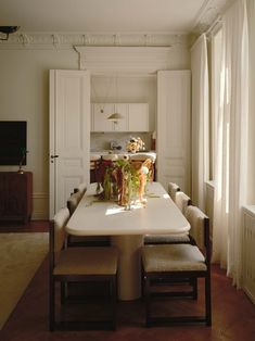 a dining room table with four chairs around it