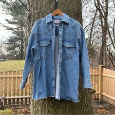 Information: Size L. Brand New Wot. Long Western Style Denim Jacket. Pockets. Pearl Snaps. Great Condition. Imperfections: None. Materials: 100% Cotton. Measurements: All Approximate: 31” From Top Of Shoulder To Bottom. 21” Across Bust When Closed. Location: Bin 15. Spring Denim Jacket With Pockets For Rodeo, Spring Rodeo Denim Jacket With Pockets, Spring Rodeo Outerwear With Pockets, Medium Wash Denim Jacket For Rodeo In Fall, Fall Rodeo Denim Jacket In Medium Wash, Casual Denim Jacket For Spring Rodeo, Long Sleeve Cotton Denim Jacket For Rodeo, Fall Rodeo Medium Wash Denim Jacket, Casual Denim Jacket For Rodeo Spring