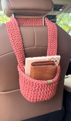 a car seat with a wallet in the back pocket and a card holder attached to it