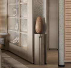 a wooden object sitting on top of a metal pole next to a window covered in blinds