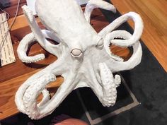 an octopus sculpture sitting on top of a wooden table