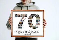 a woman holding up a framed photo with the number seventyth birthday