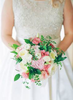 a bride holding a bouquet of flowers in her hands