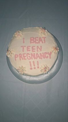 a cake that is sitting on top of a table with words written on the frosting