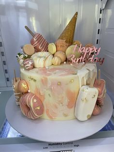 a birthday cake decorated with candy and ice cream