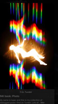 a blurry image of a person flying through the air with colored lights in the background