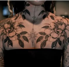 a woman with tattoos on her chest and neck