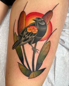 a bird sitting on top of a flower with leaves around it's legs and the sun in the background