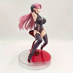 a figurine of a woman with pink hair is posed on a red base