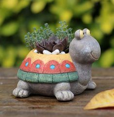 a small ceramic turtle planter sitting on top of a wooden table