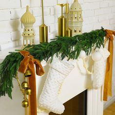 stockings and bells are hanging on the mantle