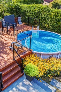 an above ground pool surrounded by wooden decking