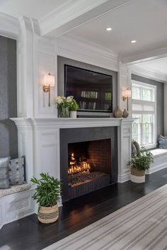 a living room filled with furniture and a fire place in front of a flat screen tv