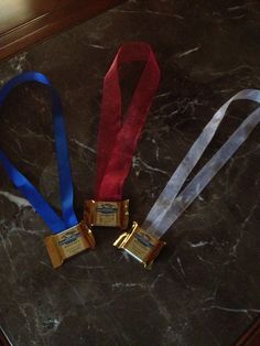 three medals sitting on top of a marble counter