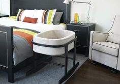 a modern bedroom with grey walls and white bedding, black headboard and foot board