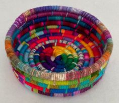 a multicolored basket is sitting on the floor