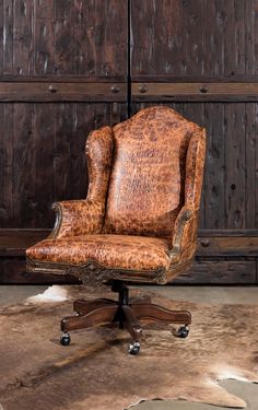 an old leather office chair sitting on top of a cowhide rug