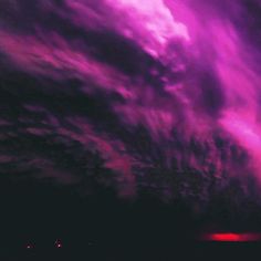 purple clouds in the sky at night time