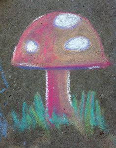 a chalk drawing of a mushroom on the ground