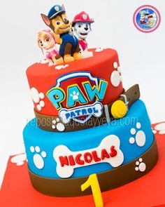 a birthday cake with paw patrol characters on top