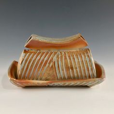 a brown and white striped ceramic dish on a table