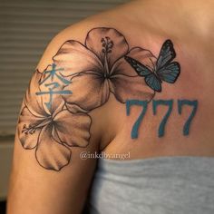 a woman's shoulder with flowers and butterflies on her left arm, which reads 777